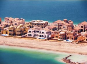UNITED ARAB EMIRATES - FEBRUARY 01:  The Palm Islands, also referred to as The Palm Dubai and The Palms, are the three largest man-made islands in the world, which are being built on the coast of the emirate of Dubai, in the United Arab Emirates (UAE). Its concept was announced in May 2002 and the three resort islands are expected to maintain position as a premium tourist destination The Palm Islands is also the self-declared 'Eighth Wonder of the World'. Each of the islands (Palm Jumeirah, Palm Jebel Ali, and Palm Deira) are being built in the shape of a date palm tree and consist of a trunk, a crown with fronds, and are surrounded by a crescent island that acts as a breakwater. The islands will support luxury hotels, freehold residential villas, unique water homes, shoreline apartments, marinas, water theme parks, restaurants, shopping malls, sports facilities, health spas, cinemas and various diving sites in Dubai, United Arab Emirates on February 01, 2007.  (Photo by Alain BENAINOUS/Gamma-Rapho via Getty Images)